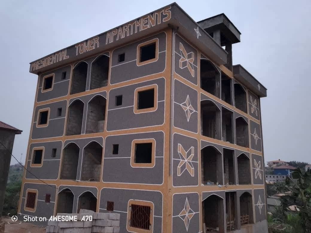 Two-storey luxury villa with brown trim and classic grey granite finish in Douala, Cameroon